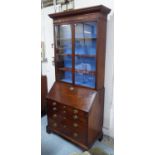 BUREAU BOOKCASE, George III mahogany with two glazed doors enclosing adjustable shelves above a