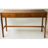 LOUGHBOROUGH WRITING TABLE, 1960's English, teak with three brass inset frieze drawers, 120cm x 46cm