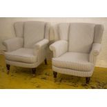 WING ARMCHAIRS, a pair, in ticking with cushion seats and brass front castors, 94cm H x 83cm. (2)