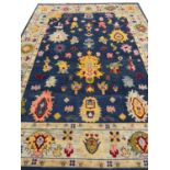 FINE CONTEMPORARY OUSHAK CARPET, 366cm x 269cm, vibrant palmette design field.