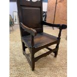 WAINSCOT ARMCHAIR, 17th century style oak, with square panel back on turned stretchered supports,