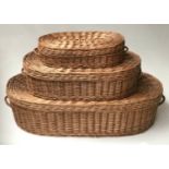 BASKETS, a graduated set of three woven wicker oval with hinged lids and handles, largest 114cm. (3)