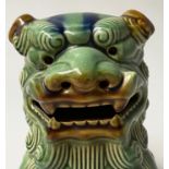 DOGS OF FOO, a pair, Chinese green and brown ceramic, 25cm H. (2)