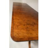 EXTENDING DINING TABLE, George III design, yew wood raised upon twin pillar outswept supports with