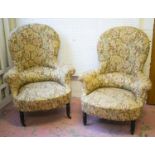 BERGERES, a pair, Napoleon III ebonised in floral patterned material (one chair lacking castors)