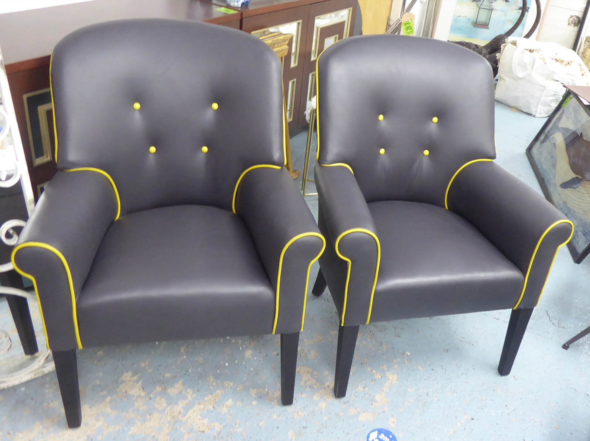 ARMCHAIRS, a pair, grey leather with yellow piping and a contrasting black velvet back, 68cm W x