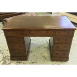 PEDESTAL DESK, Victorian walnut, with tooled leather top over an arrangement of nine drawers, 70cm D