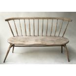 BENCH, vintage Ercol, weathered beech and elm, with solid shaped seat and swept supports and comb