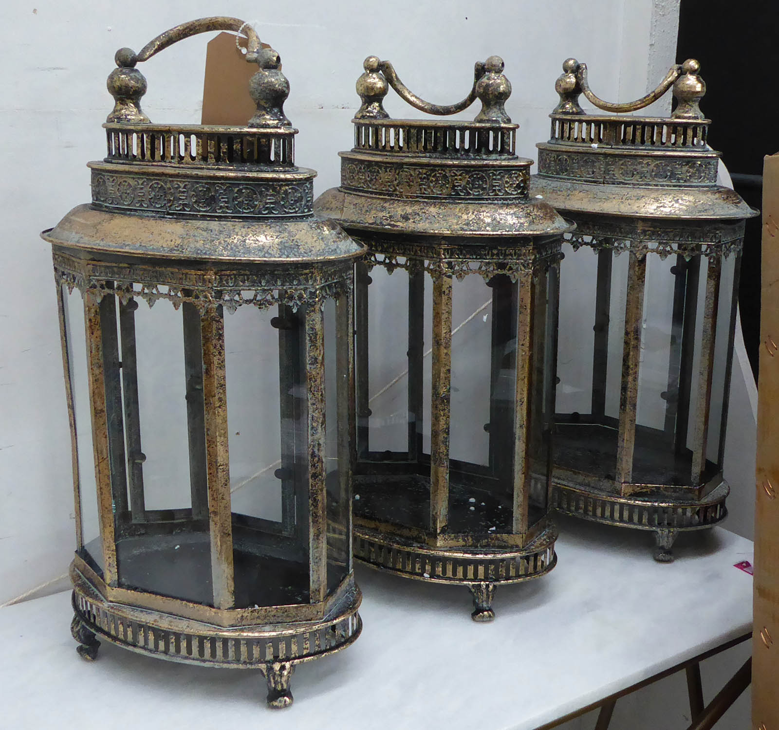 STORM LANTERNS, a set of three, antiqued gilt finish, 158cm H. (3)