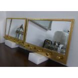 HOUSE KEEPER'S WALL MIRRORS, a pair, gilt frames with coat hooks on each, 66cm x 41cm. (2)