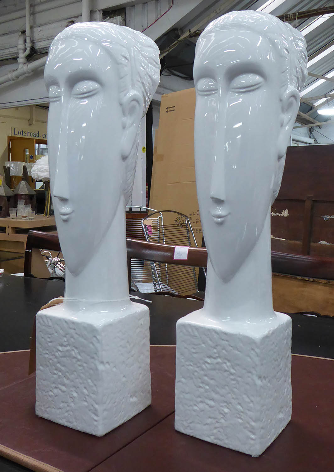 CONTEMPORARY SCHOOL BUSTS, a pair, white glazed ceramic, 61cm H. (2)