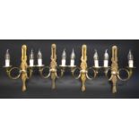 WALL LIGHTS, a set of four, brass twin branch with leaf, berry and French horn decoration, 28cm W