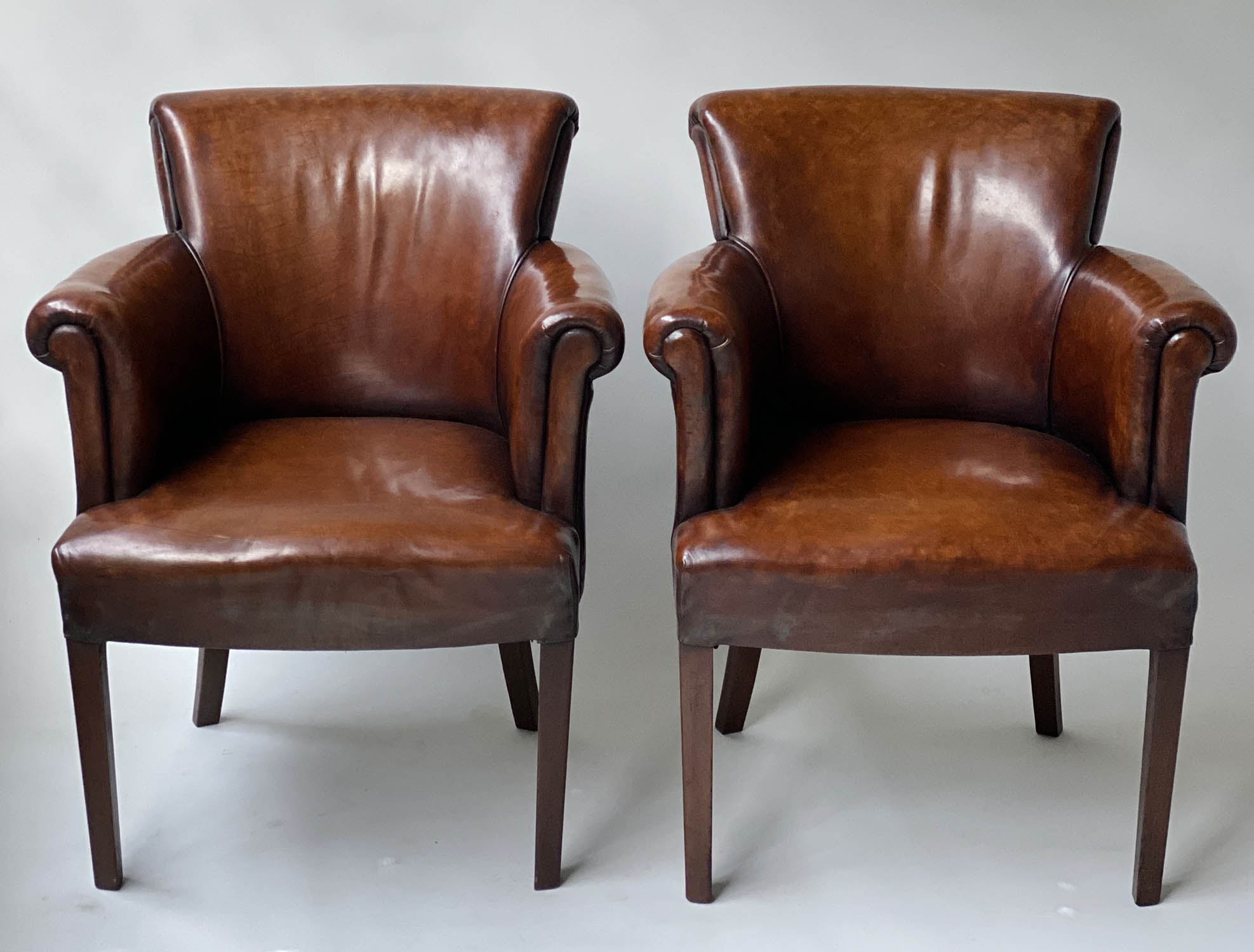 TUB ARMCHAIRS, a pair, vintage hand dyed tobacco brown leather, with arched rounded backs and