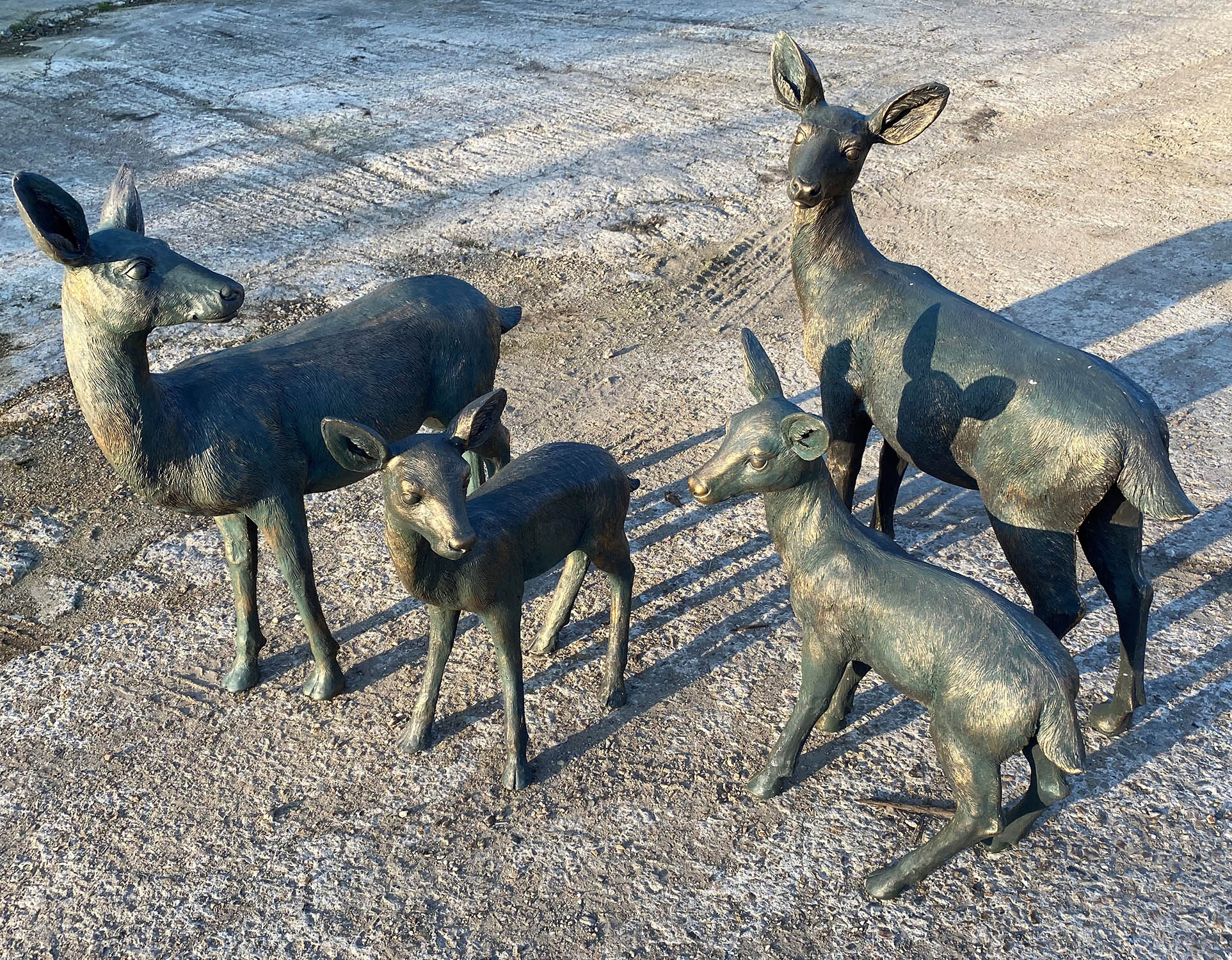 A FAMILY OF DEER, including two Does and two Fawns, gilt finish, 90cm at tallest. (4)