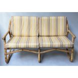BAMBOO SOFA, 1970's bamboo, cane bound and canvas slung with striped yellow twill cushions, 124cm W.