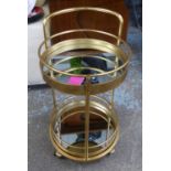 DRINKS TROLLEY, 1960's French style, gilt metal, two mirrored tiers, 76.5cm H x 45cm Diam approx.