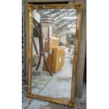 WALL MIRROR, rectangular gilt framed with mottled marginal plates, 185cm x 99cm.
