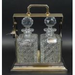 TANTALUS, Victorian style, silver plate, with two cut glass decanters with facetted stoppers and