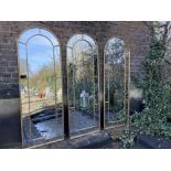 GARDEN WALL MIRRORS, a set of three, gilt metal arched top design, 62.5cm x 180cm. (3)