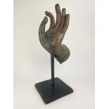 HAND OF BUDDHA, cast bronze sculpture on ebonised wooden stand, 56cm H.