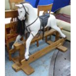 ROCKING HORSE, 20th century painted with leather saddle on pine base, 106cm H x 136cm L x 53cm.