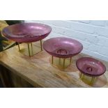 MURANO STYLE GLASS BOWLS ON METAL STANDS, a graduated set of three, largest 19cm H x 35cm D. (3)