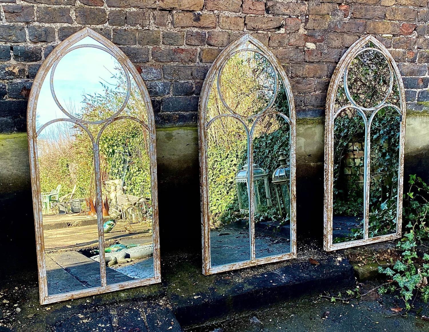 ARCHITECTURAL GARDEN WALL MIRRORS, a set of three, Gothic revival style, 122cm x 66cm. (3)