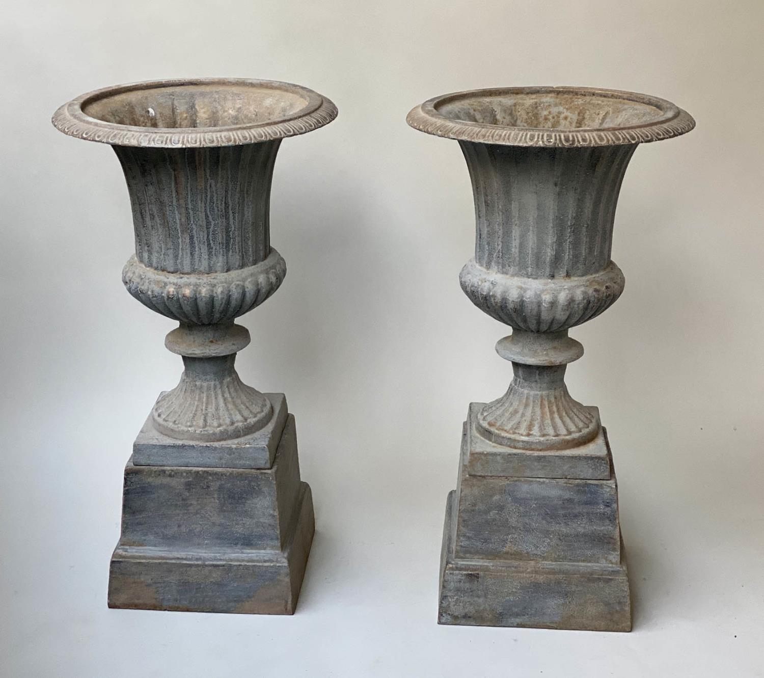 GARDEN URNS, a pair, vintage cast metal, egg and dart, fluted vase and raised plinth, 36cm x 67cm H.