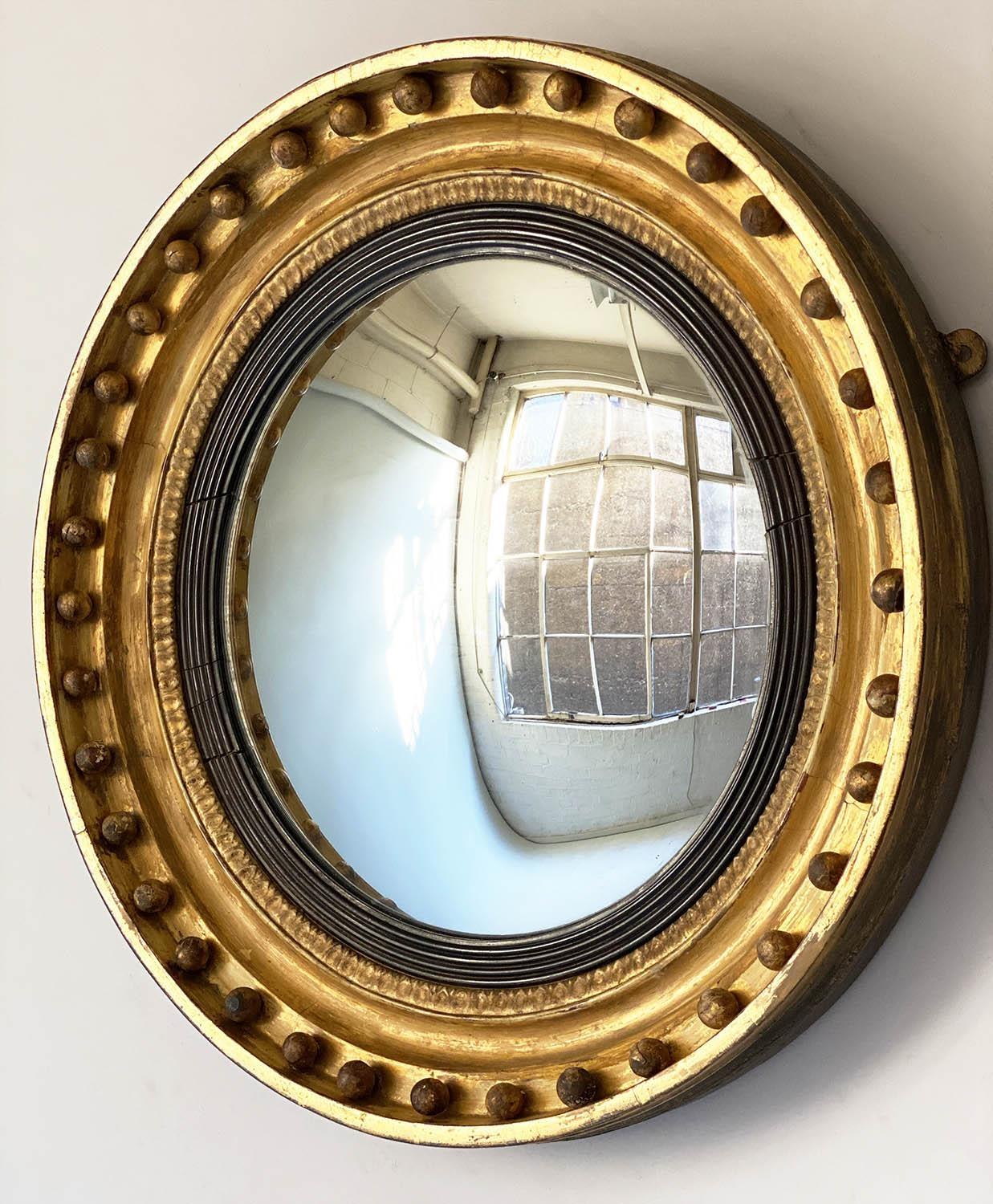 CONVEX WALL MIRROR, Regency period giltwood with ball encrusted frame, ebonised slip and convex