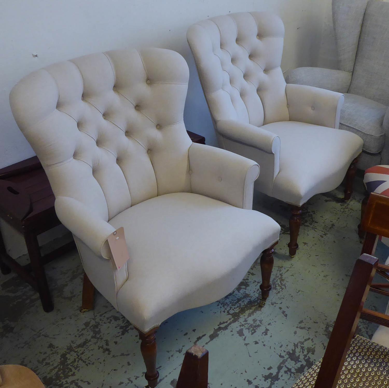 ARMCHAIRS, a pair, neutral buttoned back finish.