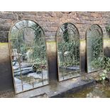 ARCHITECTURAL GARDEN MIRRORS, a set of three, gilt metal frames, 107cm x 55cm. (3)