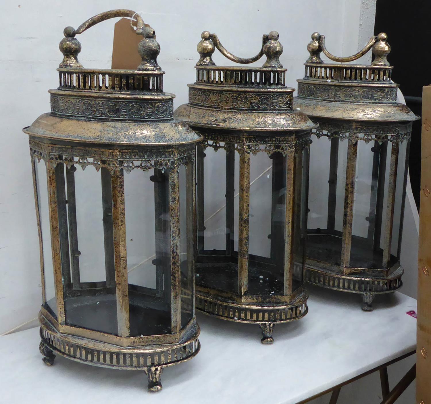 STORM LANTERNS, a set of three, antiqued gilt finish, 58cm H. (3)