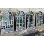 ARCHITECTURAL GARDEN MIRRORS, a set of four, aged metal frames, 60cm x 36cm. (4)