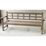 GARDEN BENCH, weathered teak slatted with flat top arms and lattice back, bears plaque 'Teak from