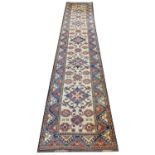 KAZAK RUNNER, 413cm x 82cm, row of geometric medallions within corresponding borders.