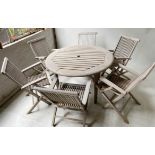 GARDEN SUITE, weathered teak circular slatted table with six folding armchairs, table 118cm x 74cm