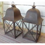 LANTERNS, a pair, iron one with a hanging sconce, 78cm H x 36cm x 36cm. (2)