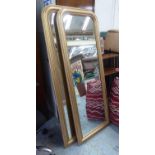 WALL MIRRORS, a pair, Victorian style, gilt frames, 148cmm x 56cm. (2)