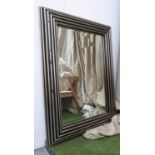 WALL MIRROR, Art Deco style with a black and silvered ribbed frame, 90cm x 120cm. (with faults)