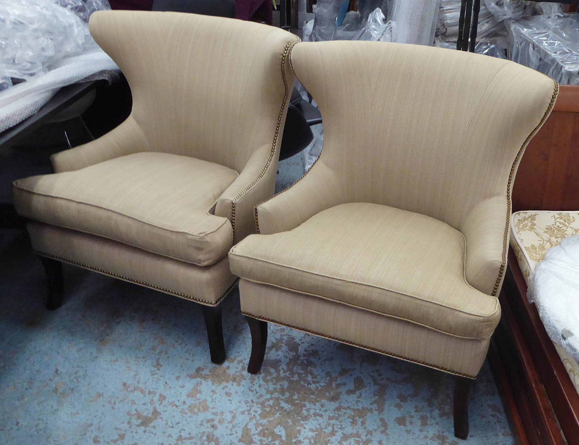 ARMCHAIRS, a pair, with neutral upholstery, 84cm W x 101cm H. (2)