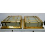 WALL LIGHTS, a pair, gilt metal with frosted glass, 48cm x 48cm x 16cm approx. (2)