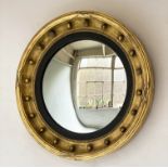 CONVEX WALL MIRROR, 19th century circular giltwood, with sphere decorated frame, ebonised slip and