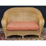 RATTAN CONSERVATORY SETTEE, 20th century, with faded red cushion seat, 147cm W.