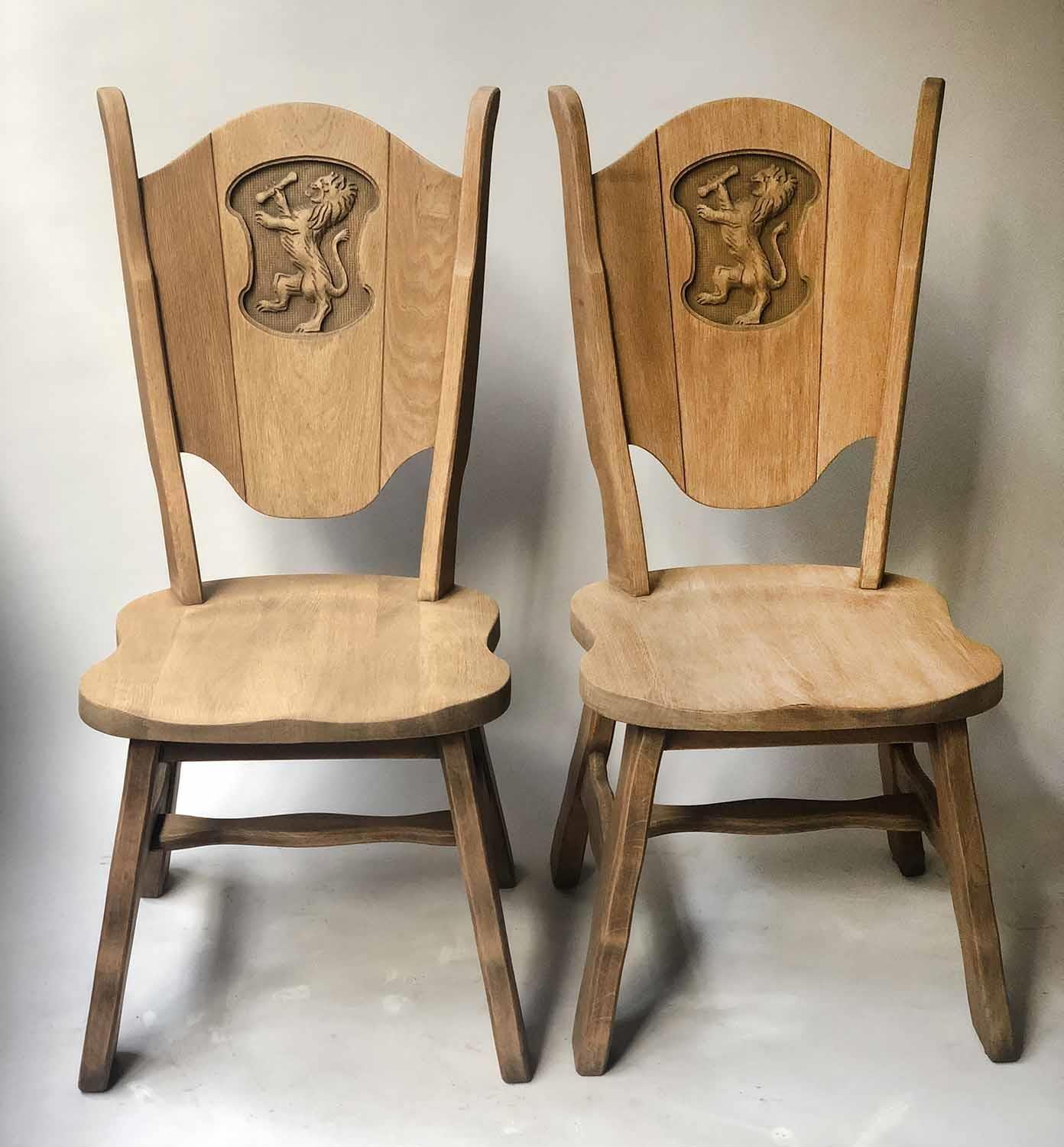 HALL CHAIRS, a pair, 20th century oak, each carved with heraldic lion, 46cm W. (2)