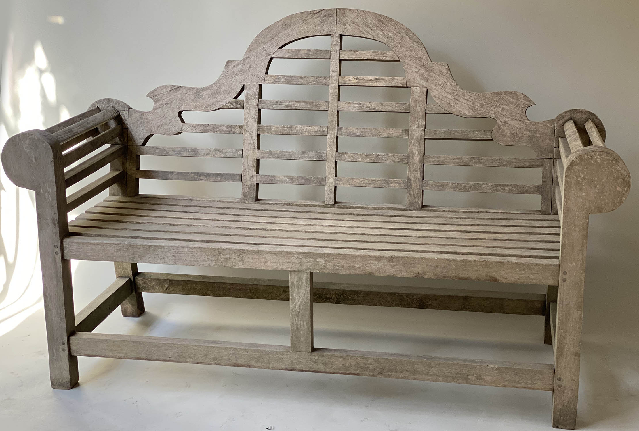 LUTYENS STYLE GARDEN BENCH, silvery weathered teak and of substantial slatted construction after a