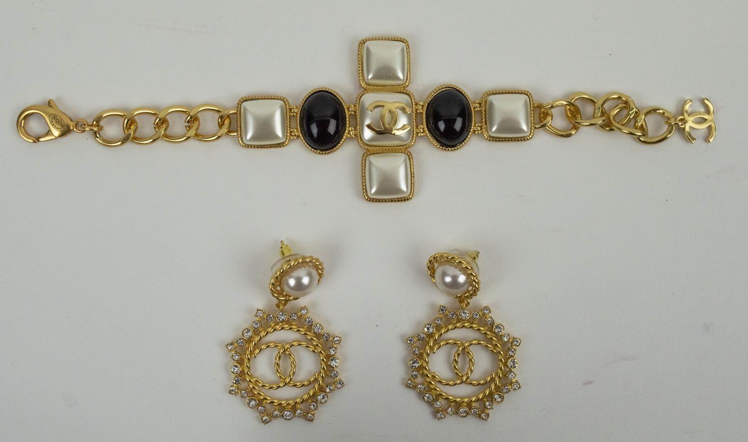 CHANEL BLACK CABOCHON SET, CC cross bracelet with a pair of faux pearl and crystal sett CC earrings.