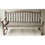 GARDEN BENCH, weathered teak of slatted construction and arched back, 155cm W.