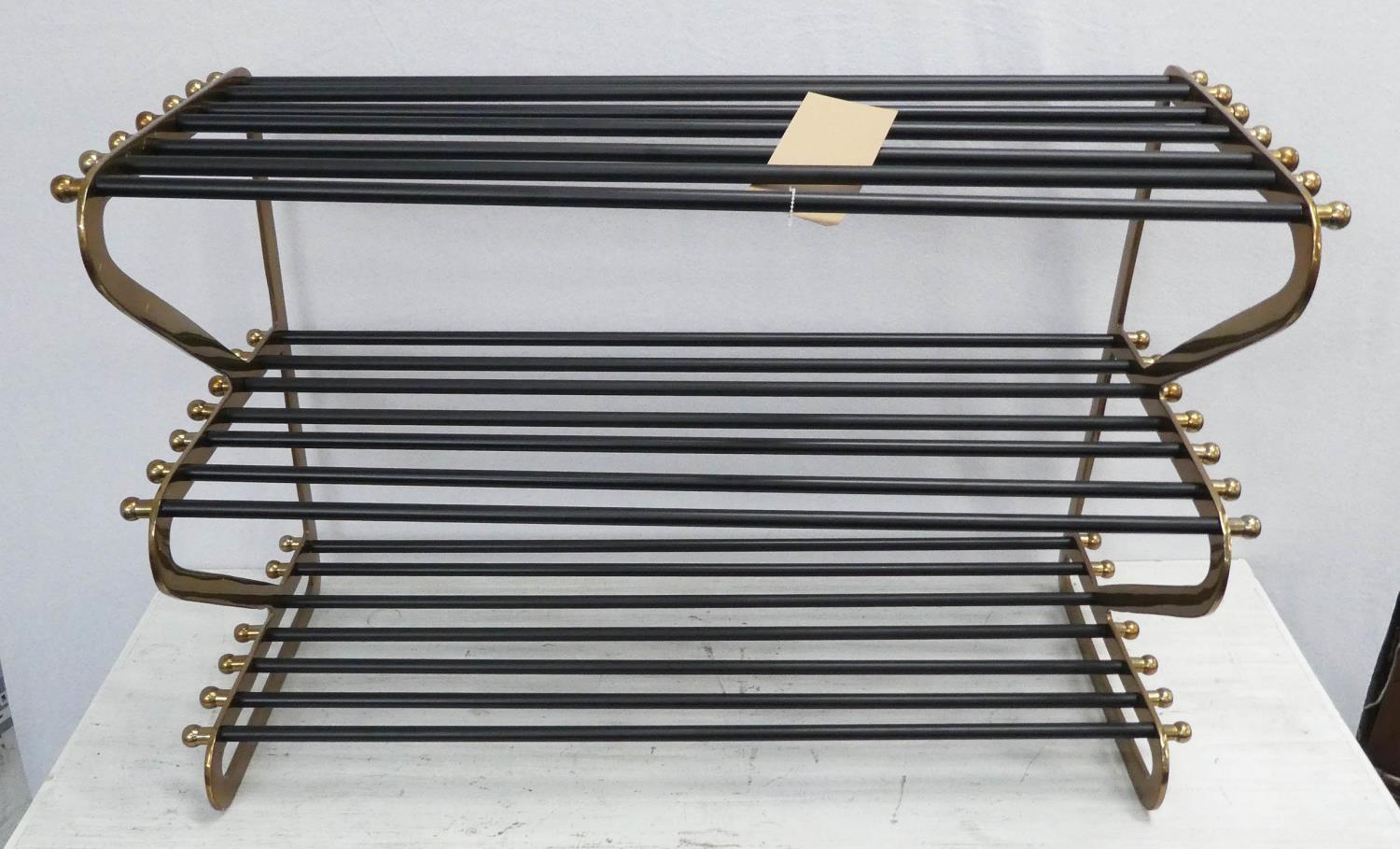 SHOE RACK, 1950's French style, gilt metal with black painted accents, 83cm x 34cm x 54cm.