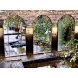ARCHITECTURAL GARDEN WALL MIRRORS, a set of three, bronzed arch top frames, 107cm x 56cm. (3)