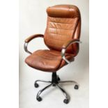 REVOLVING AND RECLINING DESK CHAIR, 1970's, stitched tan leather, on a djustable base, with castors,
